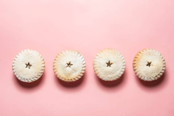 Mince pies against a Pink background.