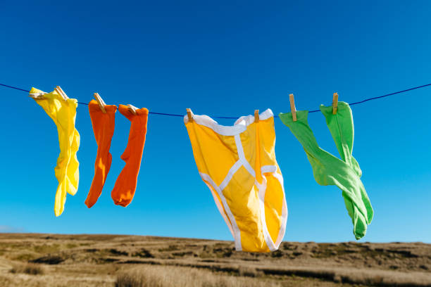 istock Vibrant coloured socks and retro Y-fronts on a washing line. 874369208