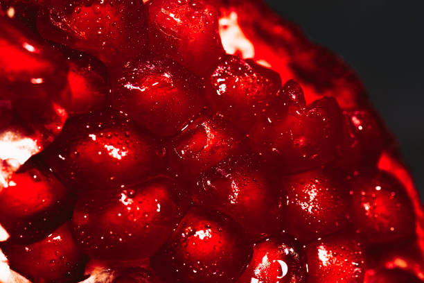 istock red sliced pomegranate on a blue abstraction background close up 874369298
