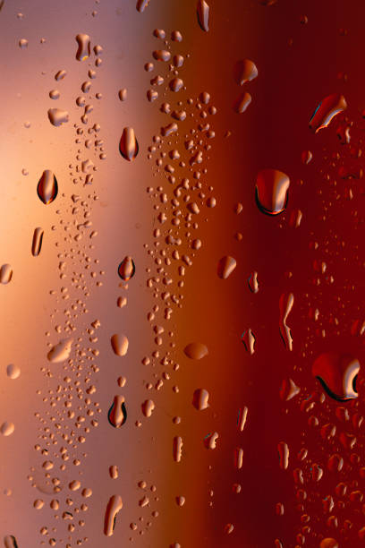 istock Drops on the glass rain red background 874371782