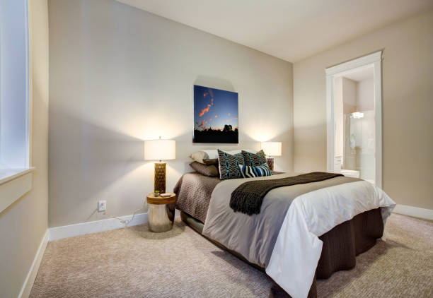 istock Neutral bedroom design with en suite bathroom 874372760