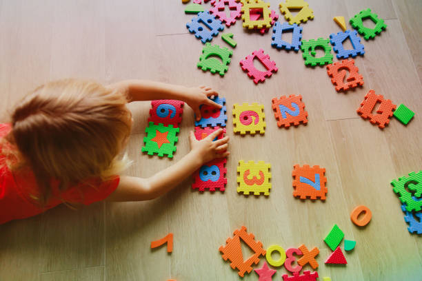 istock little girl learning numbers, education concept 874372910