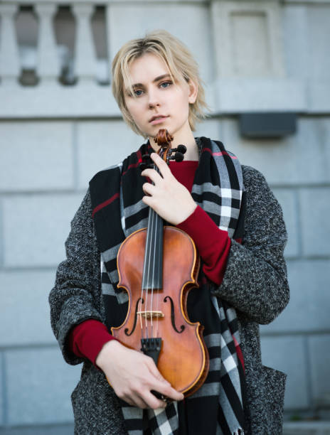 istock Beautiful girl holding violin. 874373362