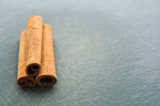 istock Cinnamon sticks lying on the table in the kitchen. Seasoning for 874379158