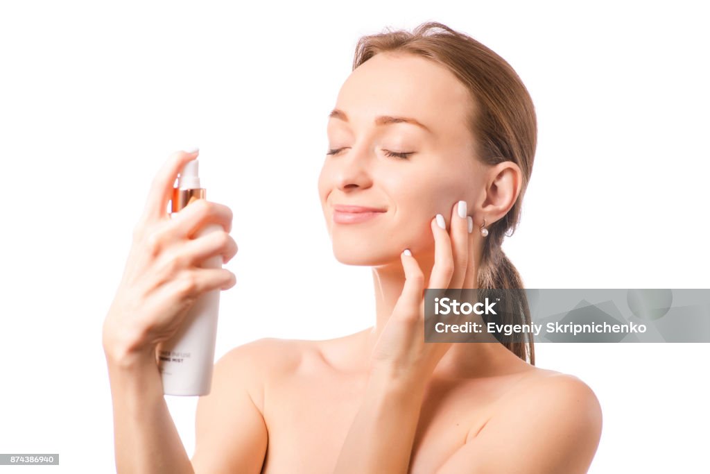 Beautiful woman face spray on face lotion cosmetology Beautiful woman face spray on face lotion cosmetology on white background isolation Human Face Stock Photo