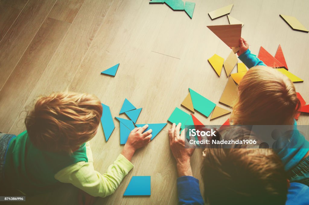 teacher and kids playing with geometric shapes teacher and kids playing with geometric shapes, learning concept Morning Stock Photo