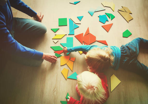 istock teacher and kids playing with geometric shapes puzzle 874387672
