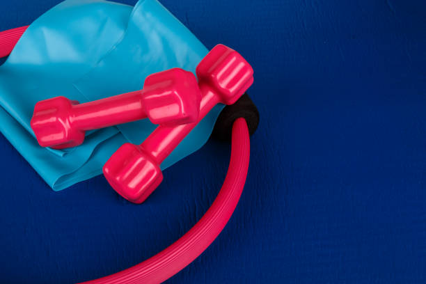 istock Pilates Circle, Dumbbell, Band on Blue Yoga Mat 874388436