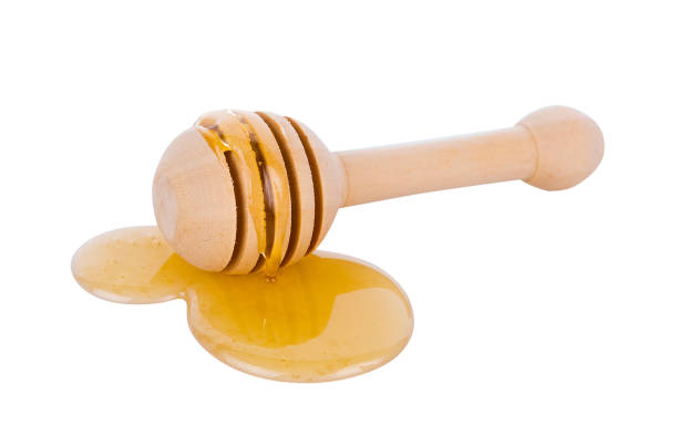 istock honey and stick isolated on white background 874395454