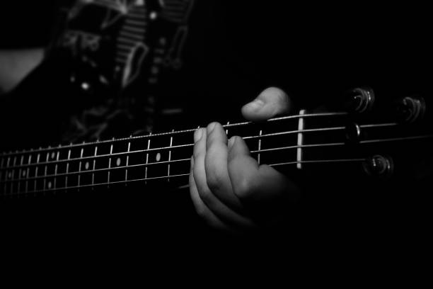 istock Bass Guitar Player Playing Bass in Music Studio 874398822