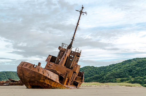 Rusty shipwreck on the shores of beach