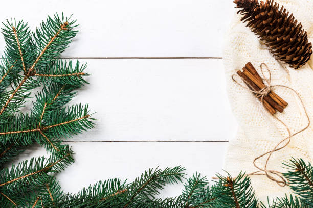 istock Christmas composition. pine cones, fir branches on wooden white background. Flat lay, top view 874399450