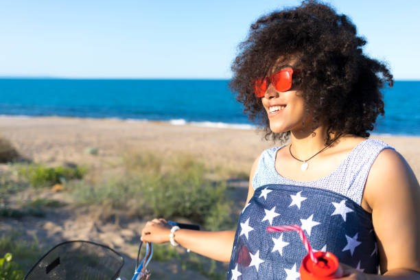 istock Woman with american flag drinking red cocktail 874399482