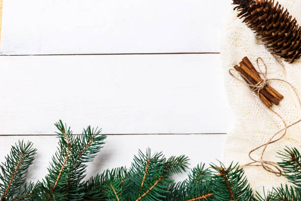 istock Christmas composition. pine cones, fir branches on wooden white background. Flat lay, top view 874399530
