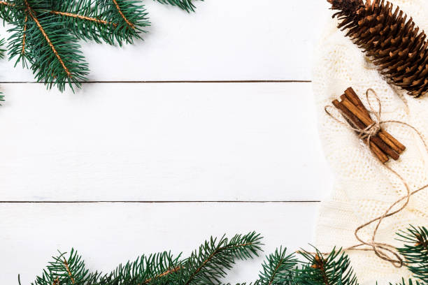 istock Christmas composition. pine cones, fir branches on wooden white background. Flat lay, top view 874399576