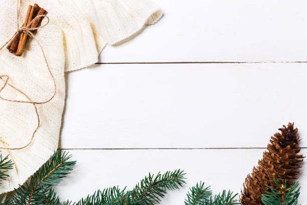 istock Christmas composition. pine cones, fir branches on wooden white background. Flat lay, top view 874401836