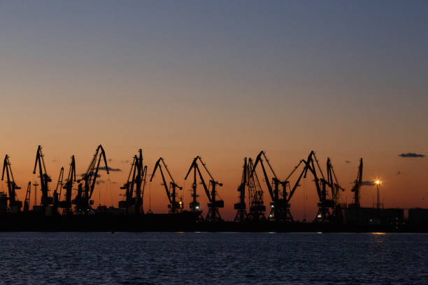 istock Many big cranes in night Berdiansk, Ukraine 874402196