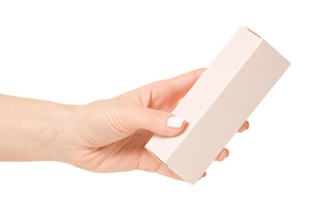 istock Female hand holding a box of cosmetic 874402246