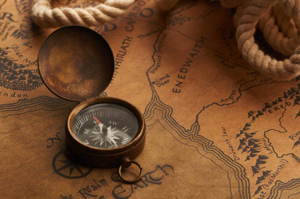 istock Old compass on a vintage map. Treasure and adventure search 874402958