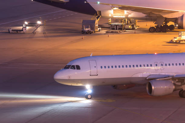 istock passenger aiplane moving on an airport at night 874403676