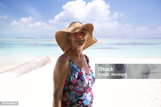 Elderly Woman On A Pristine Beach Stock Photo - Download Image Now - 70-79 Years, Active Lifestyle, Active Seniors