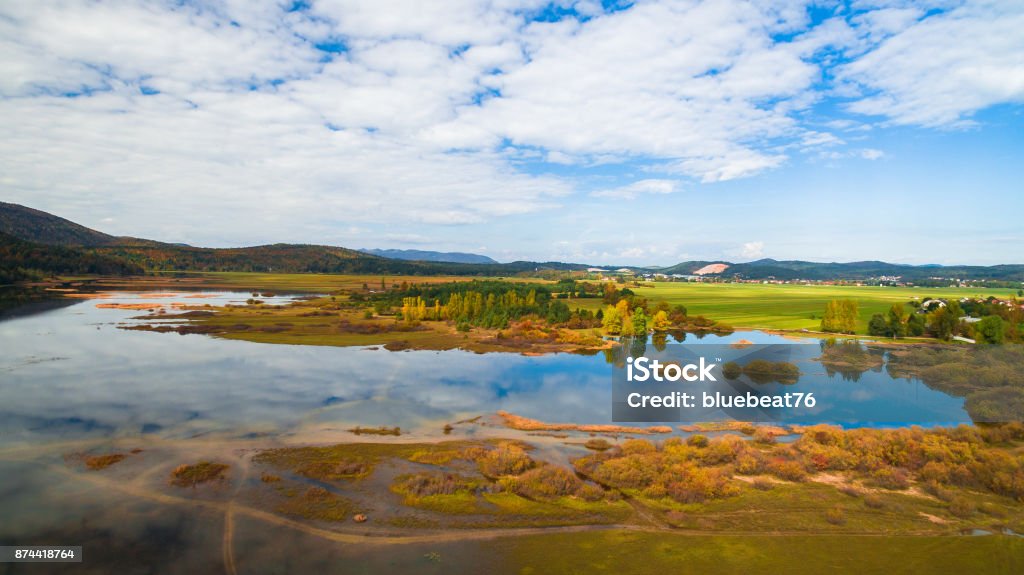 Aerial drone view of amazing autumn colors on the lake. Cerknisko lake, Slovenia Lake Stock Photo