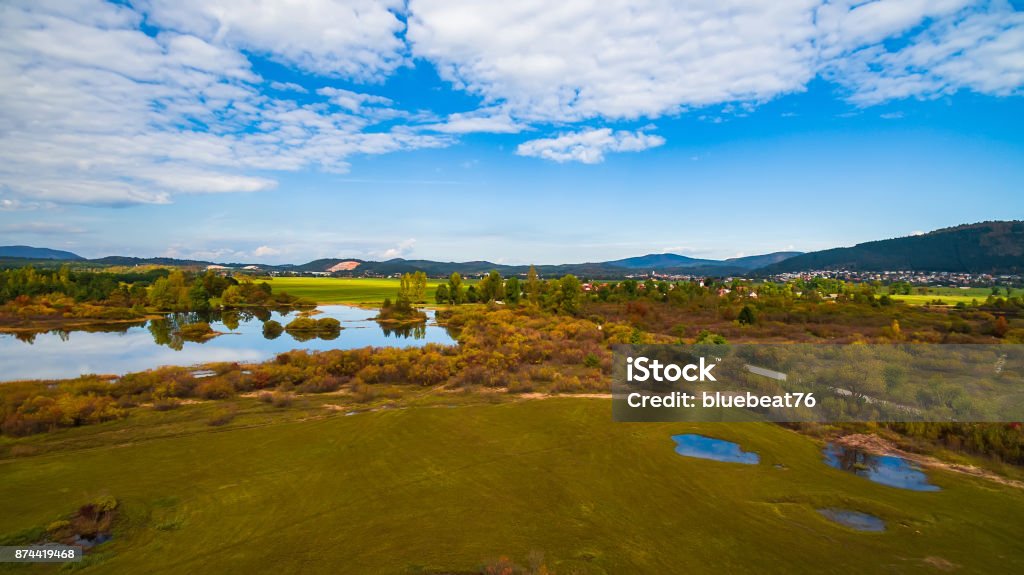 Aerial drone view of amazing autumn colors on the lake. Cerknisko lake, Slovenia Aerial View Stock Photo