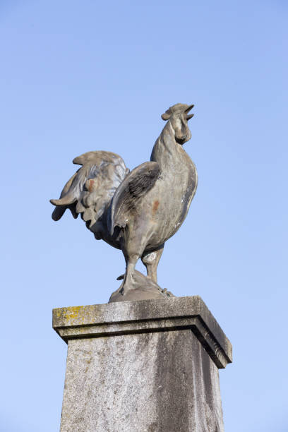 COMPREIGNAC, FRANCE - AUGUST 14, 2017: The Gallic rooster or Le Coq Gaulois from stone against a blue sky a national symbol of the French Republic.