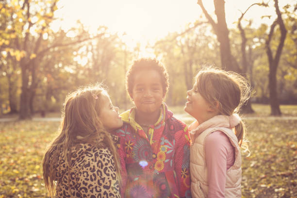 istock Three happy little girls in park. 874423000