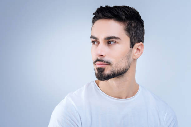 istock Elegant pleasant man looking to the left side and slightly smiling 874423972