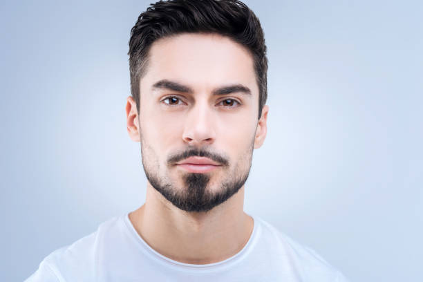 istock Young clever student looking calm before passing his exams 874424016