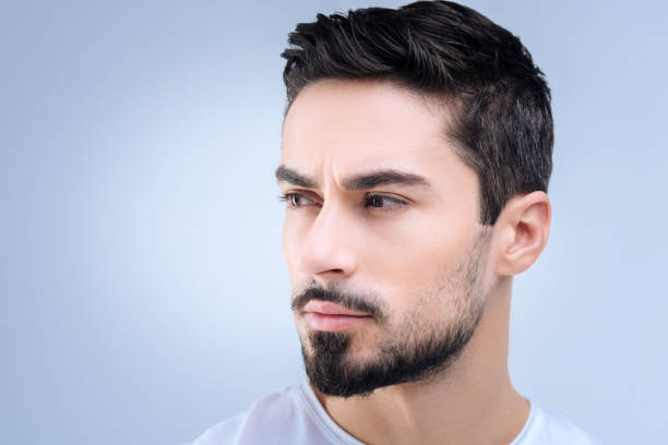 istock Calm young man looking to the right while having some suspicions 874426442