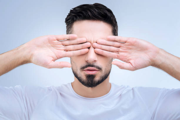 istock Tired young programmer closing his eyes after long hours of work 874427790