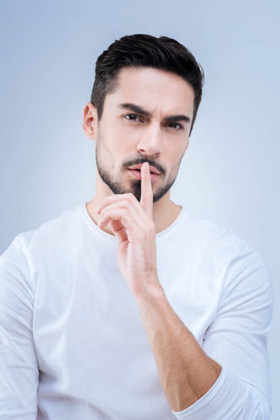 istock Serious demanding teacher asking his students to be quiet at the lesson 874428418