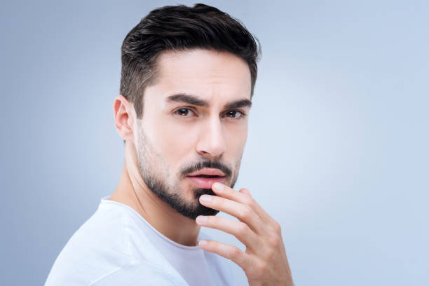 istock Sensitive man touching his lips while remembering the kiss of a girlfriend 874431666