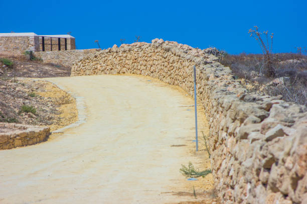 istock stone wall and road Kato Paphos Archaeological Park 874432696
