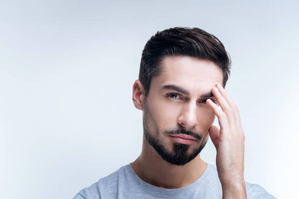 istock Ill young man having unpleasant feeling in his forehead 874441650