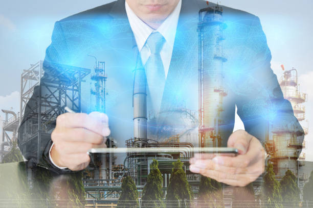 istock Double exposure of businessman working with tablet, digital light networking world map, Electric Generating, fuel oil Factory and Energy Industry plant at sunset as business and industrial concept. 874442140