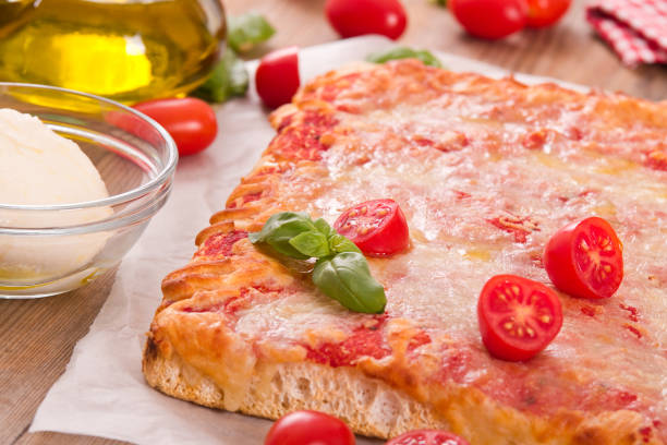istock Italian pizza with cheese, tomatoes and fresh basil. 874446030