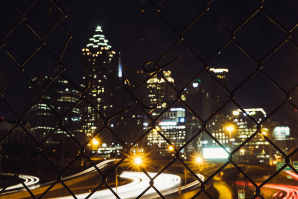 istock Blurred Atlanta background through a metal fence 874453768
