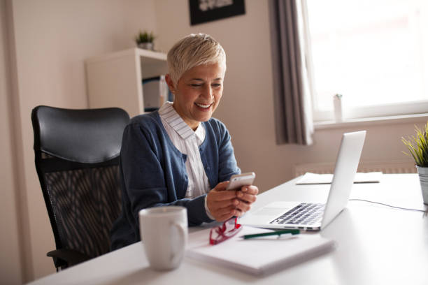istock shoot of elderly woman working in her home office. 874461104