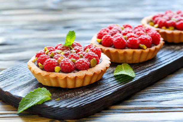 istock Tartlets with chocolate,raspberry and pistachio. 874461598
