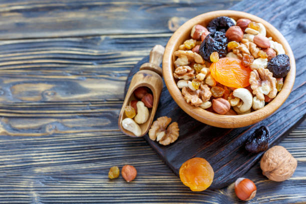 istock Nuts and dried fruit in a wooden bowl. 874464372