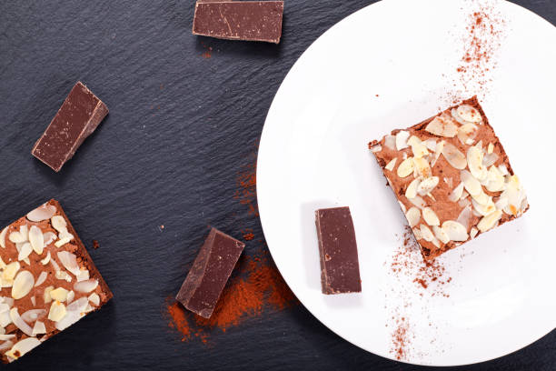 istock Homemade organic brownies on black slate stone with copy space 874464864