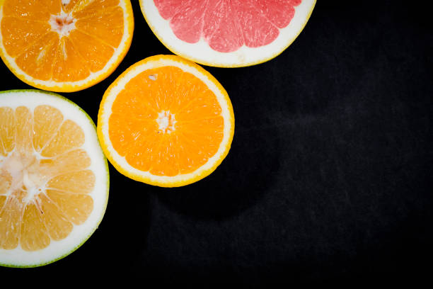 istock Citrus fruits (orange, lemon, grapefruit, mandarin, lime) on the dark background 874477352