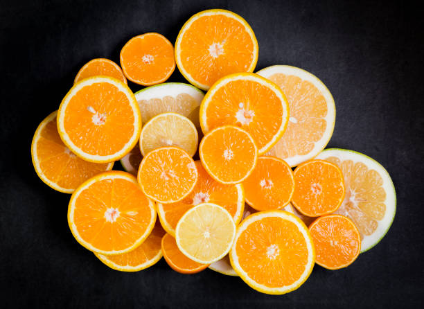 istock Citrus fruits (orange, lemon, grapefruit, mandarin, lime) on the dark background 874477422
