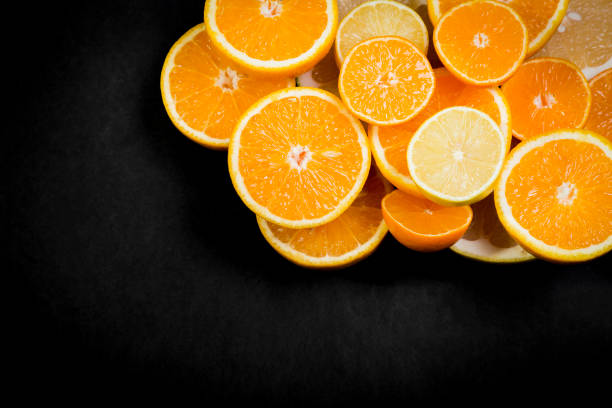 istock Citrus fruits (orange, lemon, grapefruit, mandarin, lime) on the dark background 874477424
