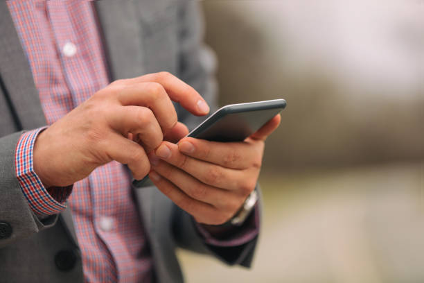 istock Business man texting on his smart phone outdoors. 874485020
