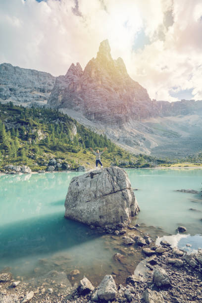 istock Hiker reaching Alpine lake, Dolomites, Italy 874486348