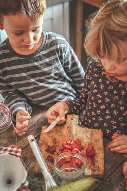 istock Preparing Homemade Strawberry Jam and Canning in Jars 874486878